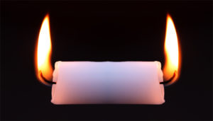A white candle with melted sides is symmetrically flanked by two large flames against a black background, creating a dramatic and reflective visual.