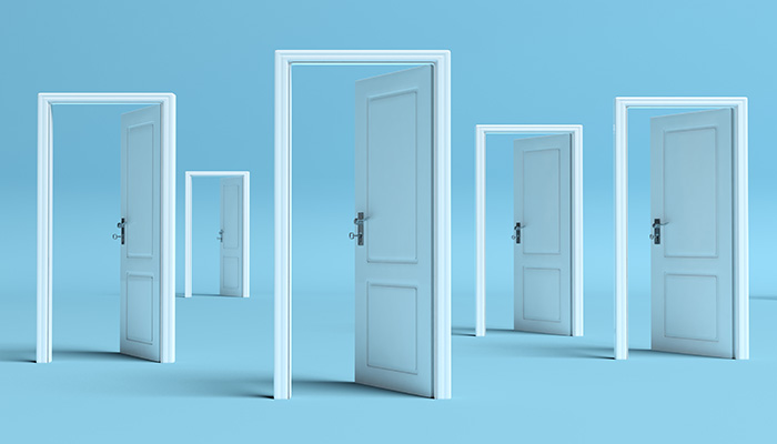 Five white doors standing open in a line, each door progressively smaller, set against a plain light blue background, creating a visual perspective effect.