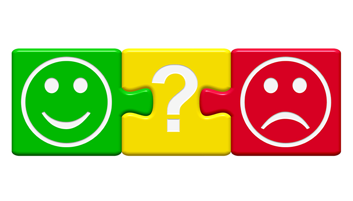 Three colorful puzzle pieces in green, yellow, and red, featuring a happy face, a question mark, and a sad face, connected in a row.